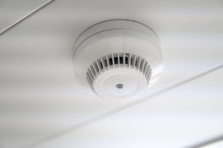 smoke detector and fire sensor on a ceiling.